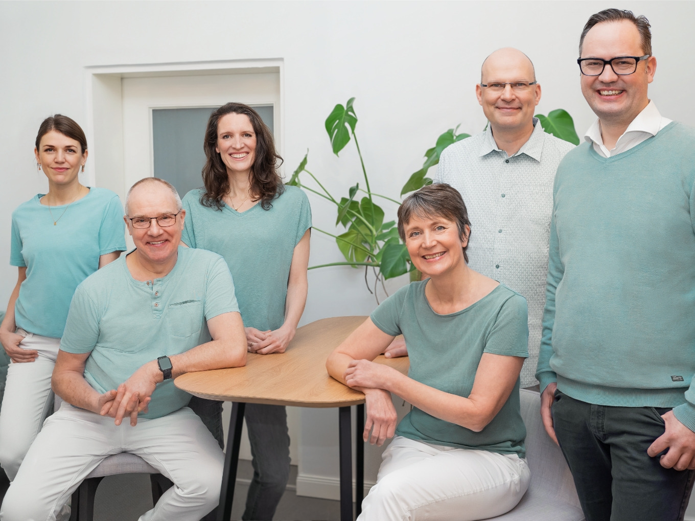 Doctors and medical assistants of the gynecologist's office in mint-colored clothes
